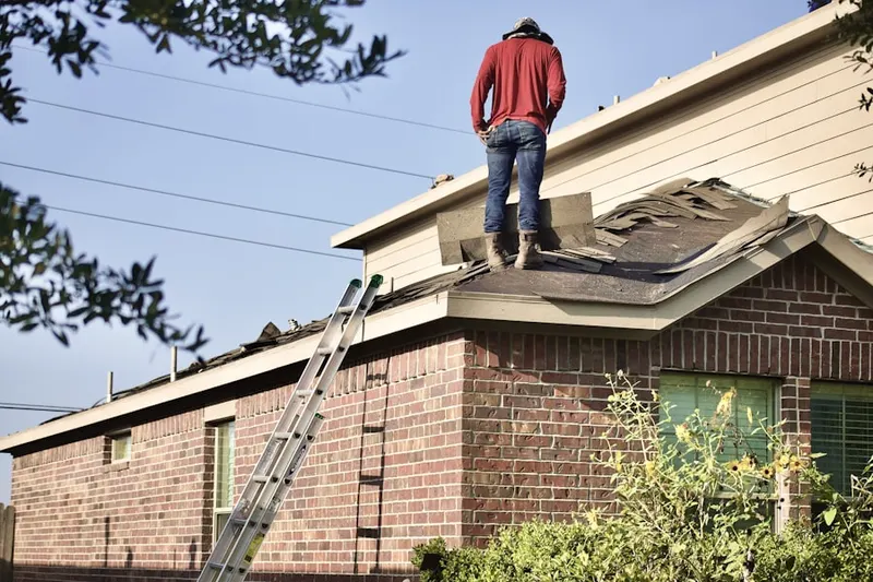 Professional roofer working on a residential roof in Lakehills
